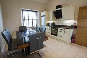 a kitchen with a table and chairs in a kitchen at Cider House in Ulverston