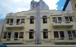 a large white building with windows on the side of it at Hotel Hilton in Juiz de Fora