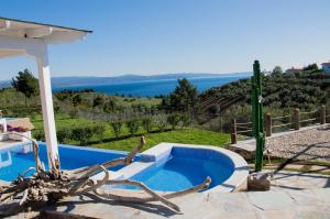 a swimming pool with a view of the water at Xalonia Villas in Agios Nikolaos