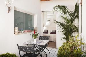 a patio with a table and chairs and a bedroom at Casa Di Capri in Capri