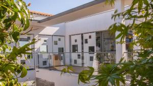 uma vista exterior de um edifício branco com janelas de vidro em Hôtel-Restaurant L'Aquarelle em Breuillet