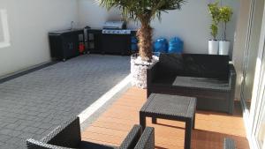 a living room with a couch and a table and chairs at Willa Exotic kryty basen in Łeba