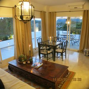 a living room with a dining room table with candles at Apartamento del paraiso in Estepona