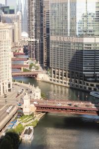 a train crossing a bridge over a river at Trump International Hotel & Tower Chicago in Chicago