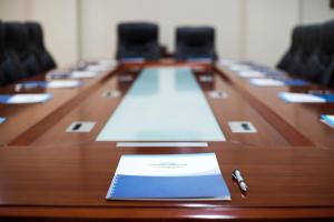 a long wooden conference table with a laptop on it at Howard Johnson Ciudad del Este in Ciudad del Este