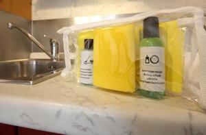 a counter with two bottles of cleaning products on it at Villa Delle Ciliegie in Deiva Marina +78 photos