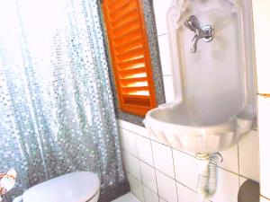 a bathroom with a toilet and a sink at Rio Antigo in Rio de Janeiro