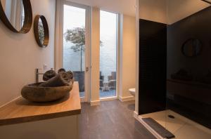 a bathroom with a large stone bowl on a counter at B&B The Butchers Wife in Bruges