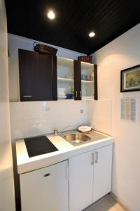 a small kitchen with a sink and a counter at The heart of Dubrovnik in Dubrovnik +43 photos