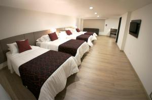 Postel nebo postele na pokoji v ubytování SM Grand Hotel