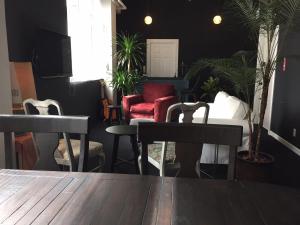 那霸ラナイ ホテルアンドドミトリー的植物间里的桌椅