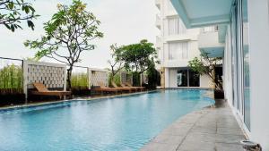 a swimming pool in the middle of a building at Paragon Hotel Seminyak in Seminyak