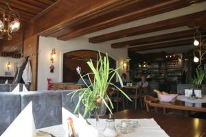 a restaurant with a table with a plant on it at Hotel Stiegenwirt in Schärding