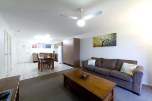 a living room with a couch and a table at Rockhampton Serviced Apartments in Rockhampton