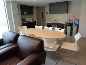 a kitchen with a table and chairs in a room at Lakehead University Residence and Conference Centre in Orillia