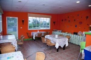 a restaurant with tables and chairs in a room at Flower Tamura in Guanshan