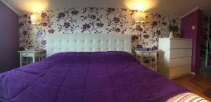 a bedroom with a purple bed with two night stands at House Anastazia Pool & Panoramic Sea View in Lovran
