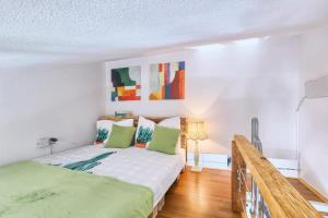 a bedroom with a bed with green pillows at Villa Marizella in Premantura