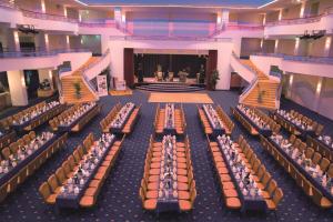 a large room with rows of tables and chairs at Hotel La Strada in Kassel +42 photos