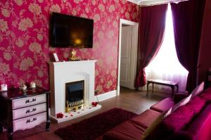 a living room filled with furniture and a fire place at Park House Hotel in Shifnal