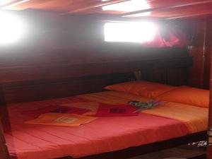 a bed in a room with a tv on the wall at Osman Aga in Palermo