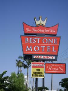 a sign for a best one motel on a street at Best One Motel in Rockhampton