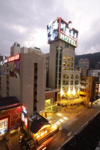 a building with a sign on it in a city at Chuang-Tang Spring SPA Hotel - Deyang in Jiaoxi