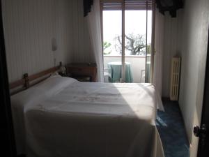 Postel nebo postele na pokoji v ubytování Piccolo Hotel Direkt am See