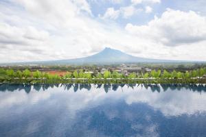 a view of a mountain with a reflection in a lake at INNSiDE by Meli&aacute; Yogyakarta in Yogyakarta