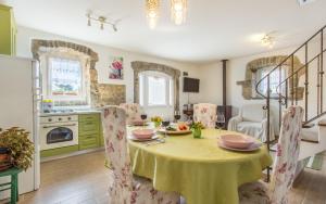 kuchnia i jadalnia ze stołem i krzesłami w obiekcie Holiday Home Eredità w Krku