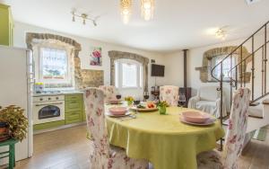 a kitchen and dining room with a table and chairs at Holiday Home Eredità in Krk