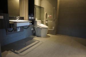 a bathroom with a toilet and a sink at Watermark Hotel Kaohsiung Main Station in Kaohsiung