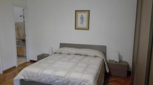 ローマにあるB&B Rome For Youのベッドルーム1室(ベッド1台付)が備わります。壁に絵が飾られています。