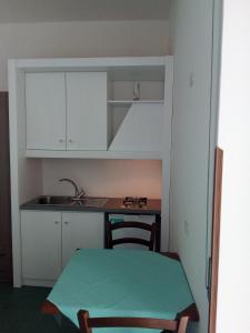 eine kleine Küche mit einem Tisch und einem Waschbecken in der Unterkunft Mira Amalfi in Agerola