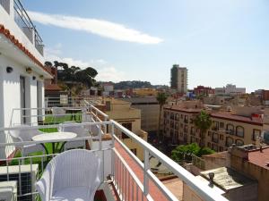 a balcony with chairs and a view of a city at Hotel Victoria in Lloret de Mar