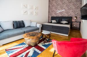 a living room with a couch and a table at Design Apartment Havelska in Prague