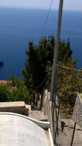 a view of the ocean from a bluff with a fence at L'Olimpo casa vacanze in Conca dei Marini