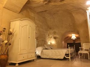 a bedroom with a bed in a stone room at La Dimora Rupestre in Matera