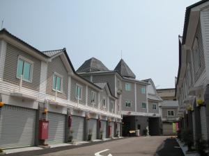 a row of houses on a street at Milan Motel in Miaoli