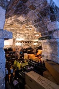 a room filled with lots of bottles of wine at Lokanda Devetak in Savogna dʼIsonzo