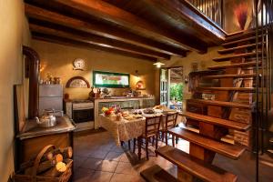 a large kitchen with a table and chairs in a room at Ecolodge Langhe in Cherasco