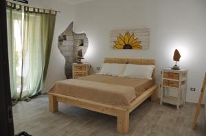 Un pat sau paturi într-o cameră la B&B Les Chambres Rooms & Suite