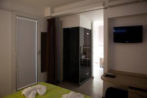 a bedroom with a black cabinet and a mirror at Hotel Santa Lucia in Bibione