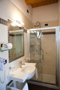 a bathroom with a sink and a shower at Hotel Santa Lucia in Bibione