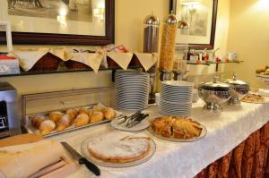 a table with bread and pastries on top of it at Villa Borgo San Pietro in Cortona