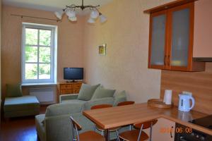 a living room with a couch and a table at Sea&Sand apartments in Juodkrantė