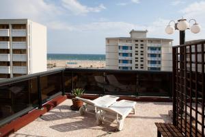 a balcony with a bench and a view of the beach at Hotel Santa Lucia in Bibione