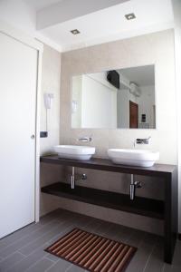 a bathroom with two sinks and a large mirror at Hotel Santa Lucia in Bibione +34 photos