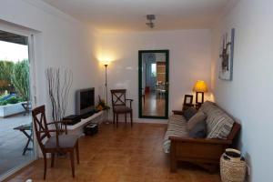 a living room with a couch and a table and chairs at Villa Benita in Playa Blanca