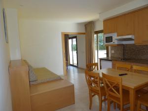 a kitchen and dining room with a table and chairs at Apartamentos Selvapark in Lloret de Mar